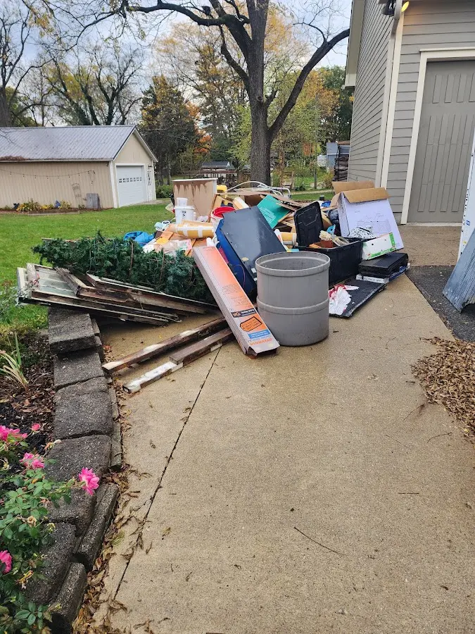 Dumpster being loaded with debris for Estate Cleanout Dumpster Rental in Hartford City